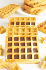 Waffles with chocolate in a close-up on a white background in a close-up, still life