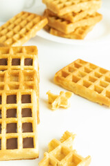 Sweet calorie waffles with chocolate in closeup on a white background