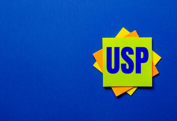 The word USP Unique Selling Proposition is written on bright stickers on a blue background