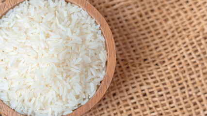 Thai jasmine rice on wood background top view and copy space, organic rice, and healthy food