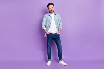 Full size photo of happy smiling cheerful good mood man hold hands pockets isolated on purple color background