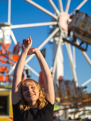 Mujer joven disfrutando de las vacaciones de verano en un parque de atracciones 