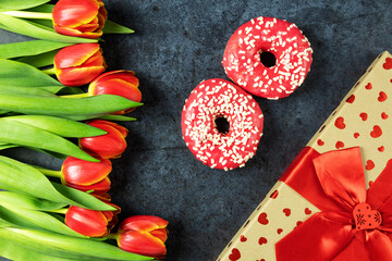 International Women's Day, March 8, Flowers Tulips with Pink Donuts on a Dark Background, Top View, Gift, Flatley