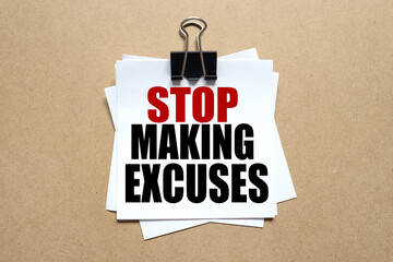 Stop making excuses . the text on the sticker. the paper is clamped with a clerical clip. paper on...