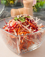 spring salad with cabbage beetroot carrot in a glass bowl