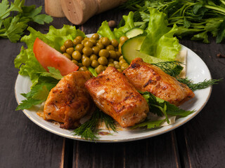 grilled chicken breast decorated with vegetables on a white plate