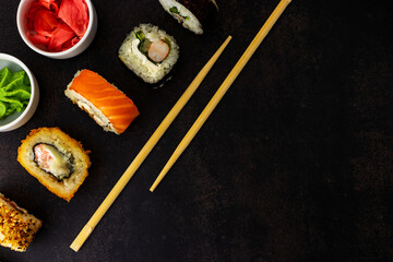 Sushi on a dark background top view with a place for an inscription