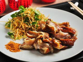 Chinese pork ears with vegetables and thin straws of French fries
