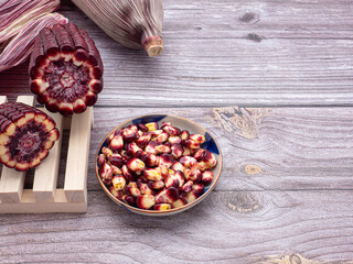 Purple corn or Siam ruby queen isolated on a white background. Side view. Concept of healthy fruit and vegetables