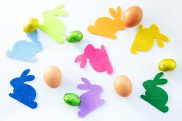 Pattern of colored hares and eggs on a white background, isolated, easter concept