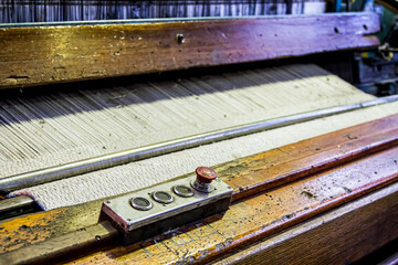 Obraz na płótnie Canvas Close up of a cotton thread weft loom machine in a conveyor belt factory