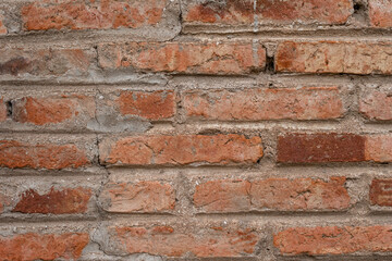 Close-up of old exposed brick wall. Texture background wallpaper.