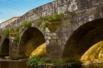 Fototapeta na wymiar Ancient bridge over small river