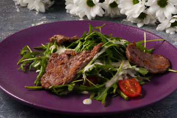 salad of fried beef, arugula and sauce. Horizontal frame