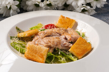 Caesar salad on a white plate. Horizontal frame