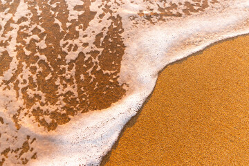 Soft sea wave on a sandy beach.