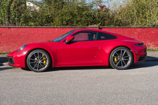 OLDENBURG, GERMANY - Apr 28, 2021: Red Sports Car Porsche Parking, Side Shot, Copy Space