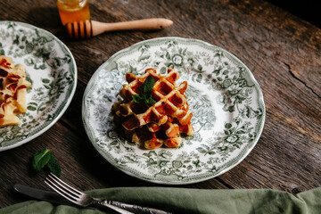 waffles with honey on a wooden background