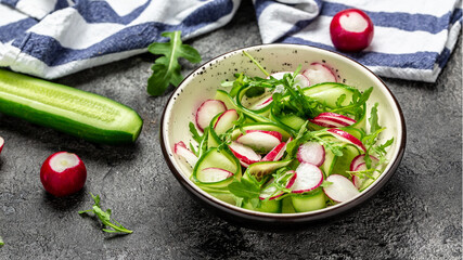Trendy salad fresh cucumbers, radish and arugula. Healthy food, diet lunch concept