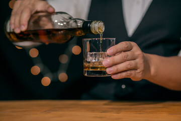 Barman pouring whiskey whiskey glass beautiful night