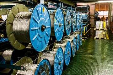 Close up view of spools of cable on a large machine in a conveyor belt factory