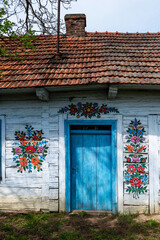 Fototapeta na wymiar ZALIPIE,POLAND - MAY 4, 2021: Colorful Village Zalipie in Southern Poland- heritage park where all houses are decorated with traditional floral motive. ..