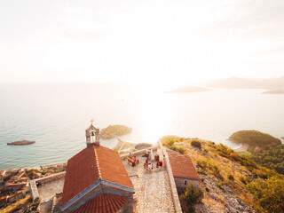 Wedding ceremony near the ancient monastery on the observation deck overlooking the island of Sveti Stefan 