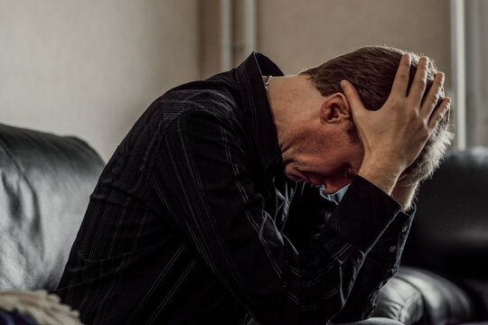 Man holding head in hands