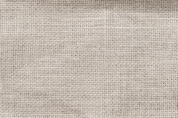 Jute hessian sackcloth woven burlap texture background in sepia cream old aged brown color