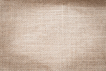 Jute hessian sackcloth woven burlap texture pattern background in old aged yellow beige cream gold brown color