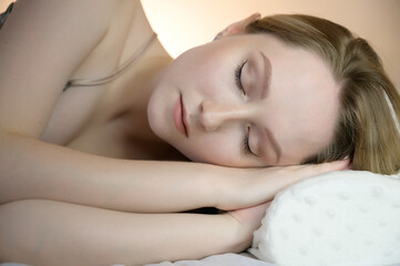 Fototapeta na wymiar Portrait of a calm young woman on pillow.