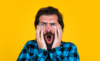 Dont tell me its true. expressing human emotions. surprised man in checkered shirt. emotional man on yellow background. brutal bearded hipster. mature guy with moustache on face