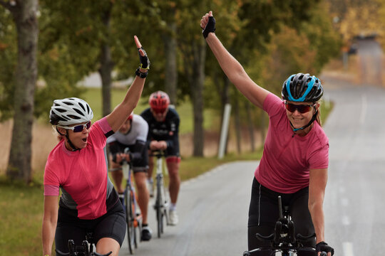 Happy cyclists giving each other high five