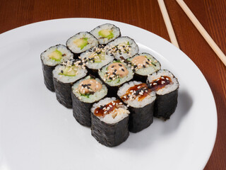 set of small sushi rolls on a white plate