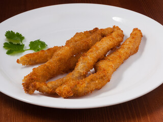 chopsticks chicken in batter on a white plate