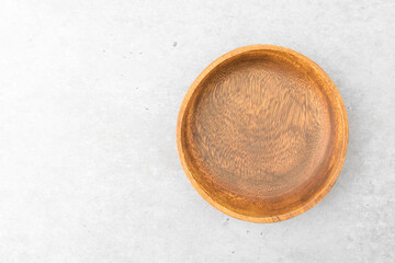 Wooden bowl on cement background