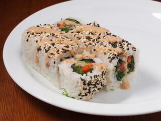 sushi roll with Chuka seaweed on a white plate