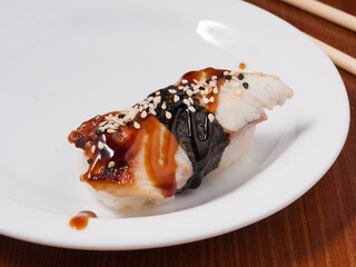 sushi with eel on a white plate. close up