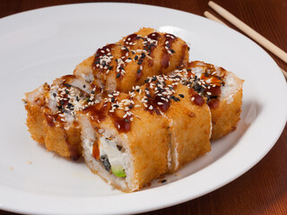 tempura sushi roll with eel on a white plate