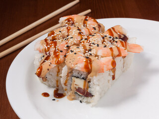 sushi roll with king prawn on a white plate