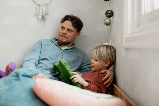 Father with son using digital tablet