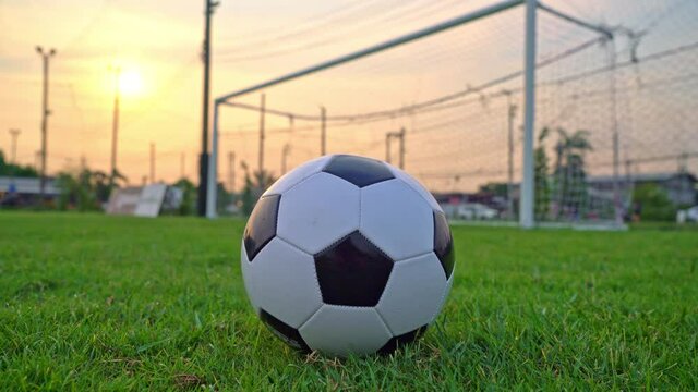 Soccer ball on the football field  background