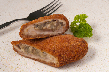 meat zrazy with mushrooms decorated with greens. close up