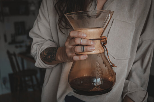 Woman holding carafe with coffee