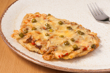 pork chop baked with vegetables and cheese. close up