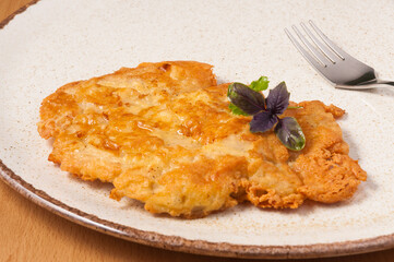 pork chop baked in a cheese crust. close up