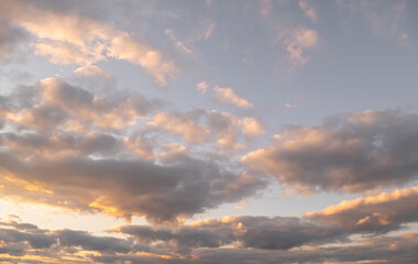 Evening sky with clouds at sunset. Scenery. Wallpaper. Horizontal photo with place for text. 