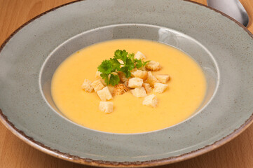 mashed soup with croutons decorated with herbs. close up