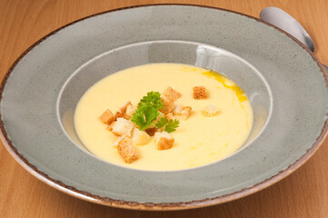 mashed soup with croutons decorated with herbs. close up