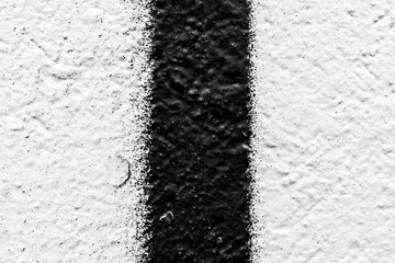 Rough white wall with black vertical line. Close up view